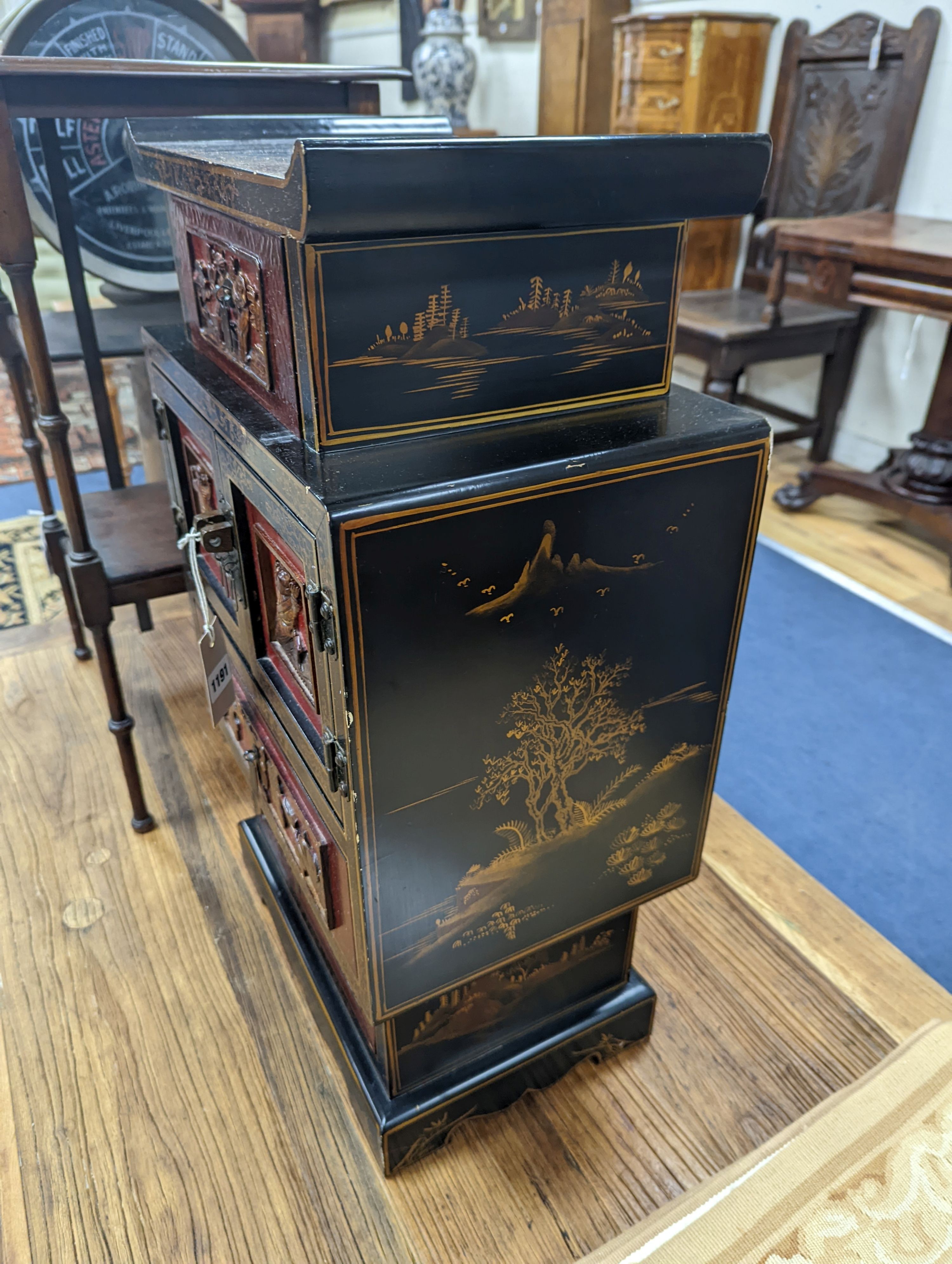 A late 19th century Chinese red and black lacquered cabinet, width 39cm, height 66cm